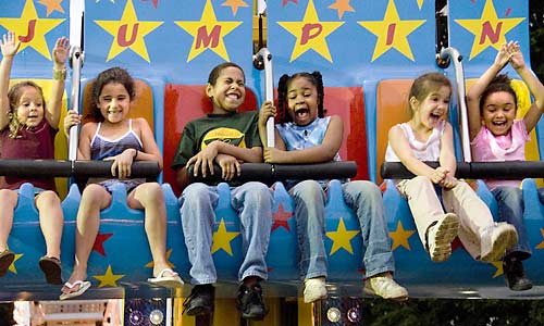 photo: Children thrilled and fearful on carnival ride