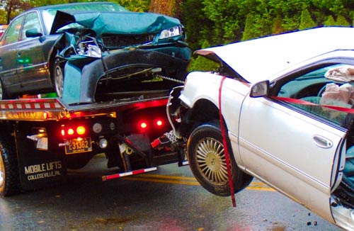 two cars on tow truck