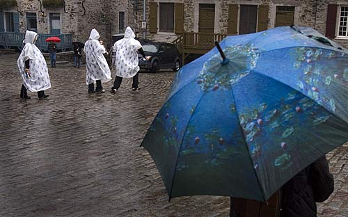 tourists in rain slickers, umbrellas in Quebec