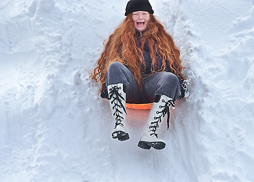 woman snow sledding