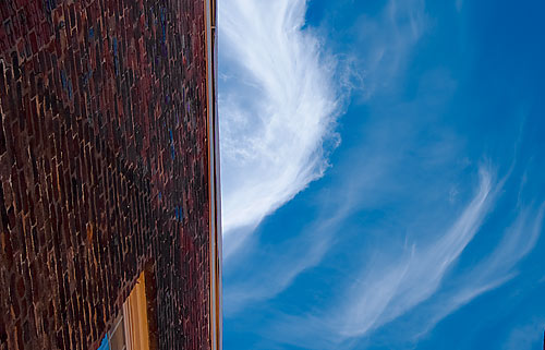 clouds above bricks