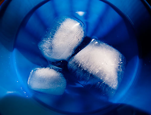 ice cubes melting in blue plastic cup