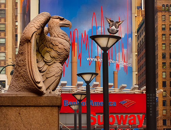 Stone eagle and rising pigeon looking north from the 7th Avenue side of Madison Square Garden, New York City, NY.