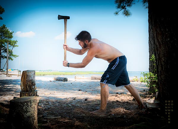 Lifeguard splitting wood with an axe at Camp Arrowhead