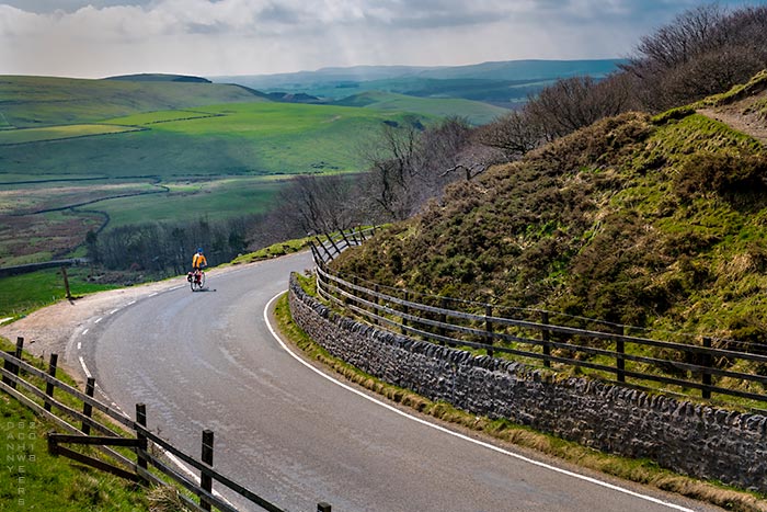 Photo of bicyclist below Mam Tor, Derbyshire Peak District, England