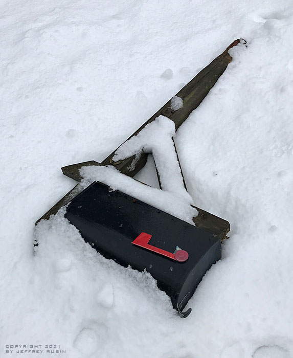 Photo by guest photographer Jeffrey Rubin of a mailbox knocked down in the snow.