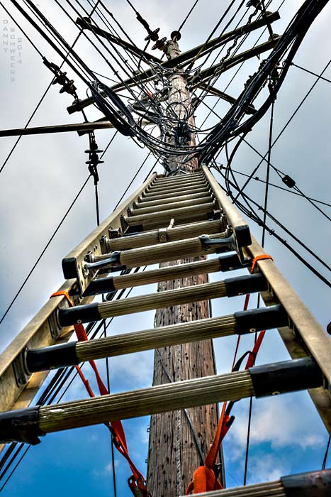 ladder leading up to electric and telephone wires, to Internet and fiberoptic cables. Photo copyright 2014 and text copyright 2021 by Danny N. Schweers