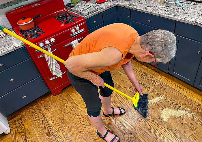 Photo of the artist’s wife sweeping up the rice he had spilled, copyright 2021 by Danny N. Schweers