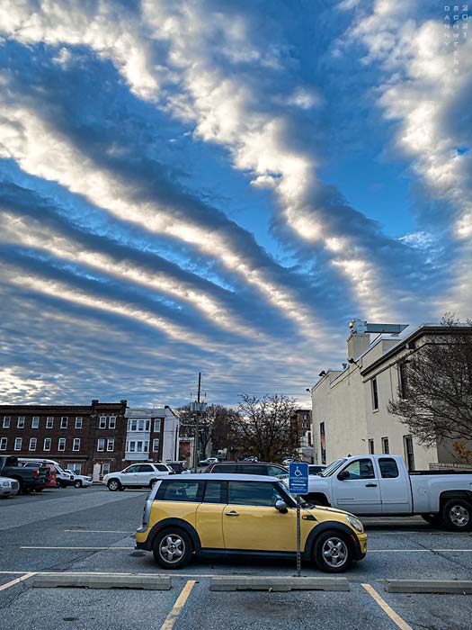 Photo of parallel clouds above parking lot in Wilmington, Delaware copyright 2021 by Danny N. Schweers.